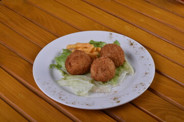 Deep-fried cheese balls on a plate and ketchup. Deep fried Cheese balls. Crispy Cheese. Deep Fried Rice Balls, arancini.