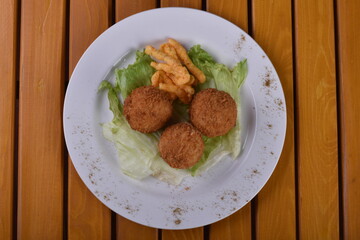 Deep-fried cheese balls on a plate and ketchup. Deep fried Cheese balls. Crispy Cheese. Deep Fried Rice Balls, arancini.