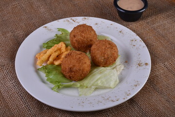Deep-fried cheese balls on a plate and ketchup. Deep fried Cheese balls. Crispy Cheese. Deep Fried Rice Balls, arancini.