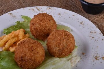 Deep-fried cheese balls on a plate and ketchup. Deep fried Cheese balls. Crispy Cheese. Deep Fried Rice Balls, arancini.
