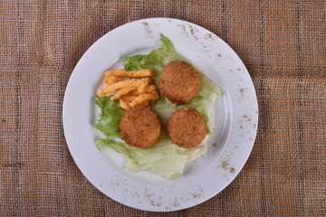 Deep-fried cheese balls on a plate and ketchup. Deep fried Cheese balls. Crispy Cheese. Deep Fried Rice Balls, arancini.