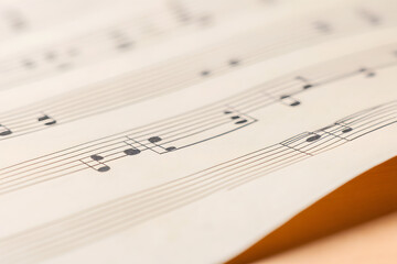 Fototapeta premium Macro Shot of Wavy Music Sheet with Notes | Close-Up View of Musical Composition and Sheet Music Art