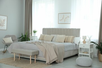Big comfortable bed in room. Interior design