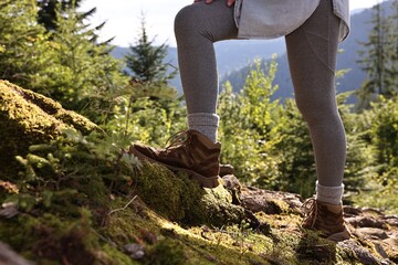 Young hiker wearing trekking shoes outdoors, closeup