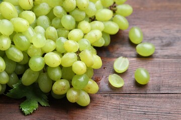 Fresh ripe grapes on wooden table, closeup