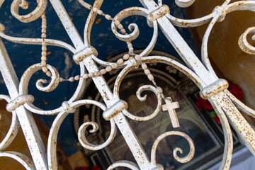 Wooden rosary hanging on the chapel trellis.