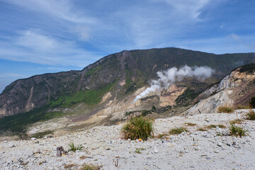 Steaming Crater on a Serene Mountain Slope