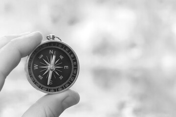 Classic navigation compass on natural background