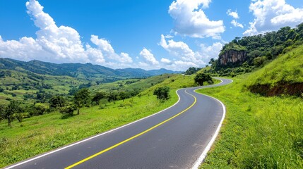 Fototapeta premium Serene Winding Highway Through Majestic Mountains and Lush Countryside