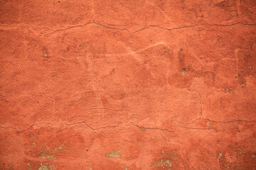 Old orange damage cracked wall in closeup
