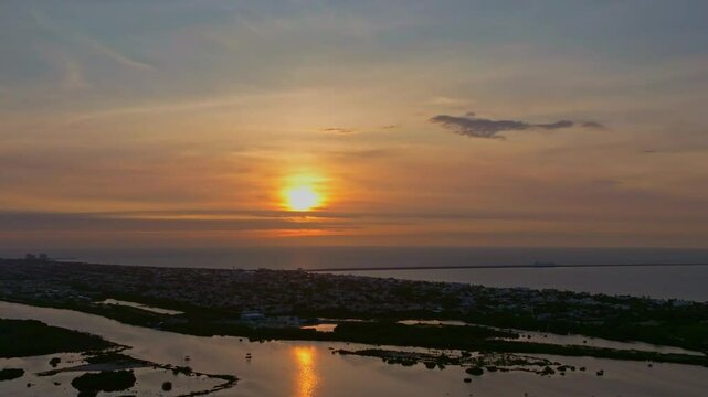 Aerial view of a beautiful sunset over the tranquil ocean and picturesque cityscape, Progreso, Mexico.