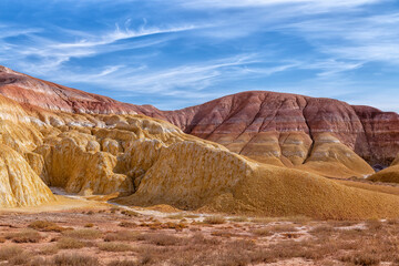 Akzhar Ulytau chalk mountains in the desert of Kazakhstan. Rare sandy hills with many multi-colored layers of clay, sand, chalk and gravel of bizarre shape far from civilization with sparse vegetation