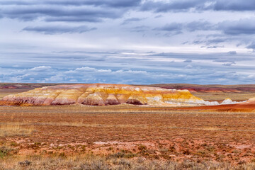 Akzhar Ulytau chalk mountains in the desert of Kazakhstan. Rare sandy hills with many multi-colored layers of clay, sand, chalk and gravel of bizarre shape far from civilization with sparse vegetation