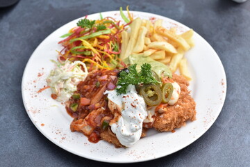 Fried chicken schnitzel cordon bleu with cheese in breadcrumbs is restaurant food. Delicious tender...