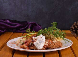 Fried chicken schnitzel cordon bleu with cheese in breadcrumbs is restaurant food. Delicious tender chicken chnitzel with homemade french-fries