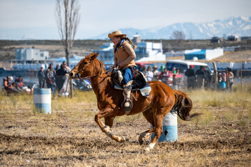 Gaucho (woman) on horseback in Creole skill games. Argentina