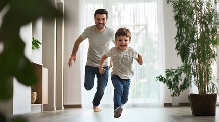 A father and his son run playfully through a brightly lit room.