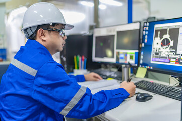 Computer engineers developing software programs to control industrial machinery,optimizing automation processes,and improving production flow in a high-tech factory setting