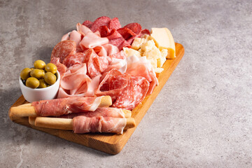 Charcuterie board. Antipasti appetizers of meat platter with salami, prosciutto crudo or jamon and olives.