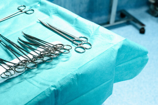 Surgical instruments arrayed on sterile blue cover