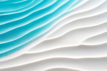 Close-up of smooth, wind-blown sand dunes with ripples and patterns, featuring golden sands against a clear blue sky