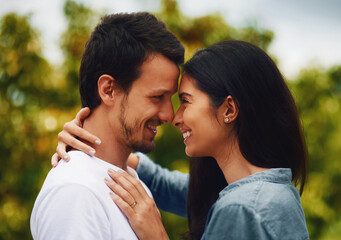 Love, hug and bonding with couple in park for romance, smile and summer vacation. Happiness, commitment and care with man and woman relax on date in nature for marriage, support and partnership