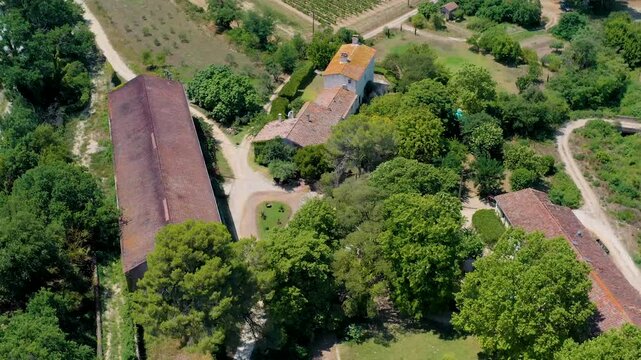 Aerial view of the picturesque Canal du Midi near Capestang with luxury ships and lush vineyards, Aude, France.