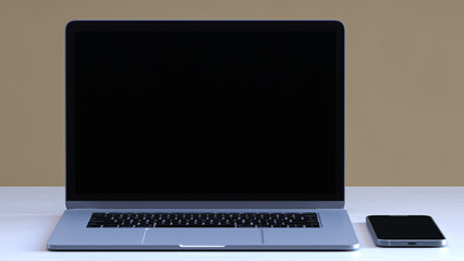 Laptop with smartphone on the table