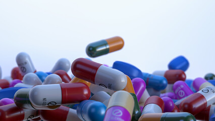 Pills of various shapes and colors on a white background