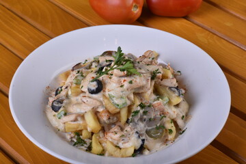 A top-down view of a bowl of chicken shawarma fries. Loaded fries on the table