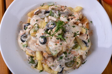 A top-down view of a bowl of chicken shawarma fries. Loaded fries on the table