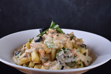 A top-down view of a bowl of chicken shawarma fries. Loaded fries on the table