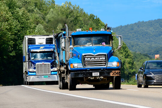 A Heavy Dump Truck In Traffic On Busy Interstate Highway