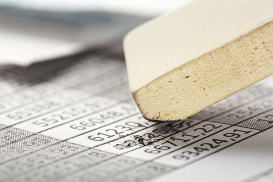 Fix with eraser financial data in document. Concept of banking, financial report and financial audit.