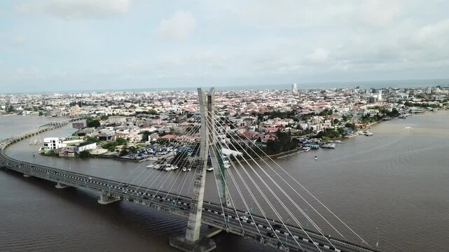 Aerial view of vibrant cityscape with bustling bridge and river, Lagos Island, Nigeria.