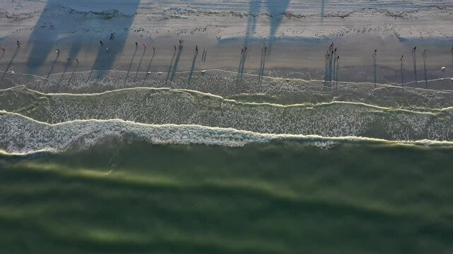 Aerial view of serene beach with people walking, St. Pete Beach, Florida, United States.