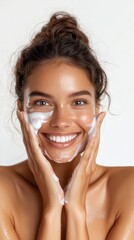 Woman washing face with cleanser, smiling joyfully, fresh clean skin routine