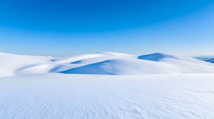 A serene winter landscape with untouched snow covering rolling hills under a clear blue sky