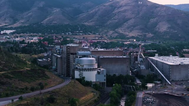 View of Coor's factory from above with mountains, aerial footage, Golden, Colorado, 4K