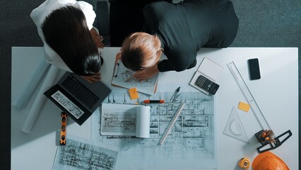 Top view of businesswoman hand blueprint to engineer sitting at meeting table with project plan,...
