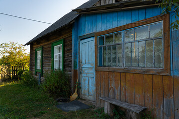 An old, rustic house in the evening in the village. Old Slavonic House