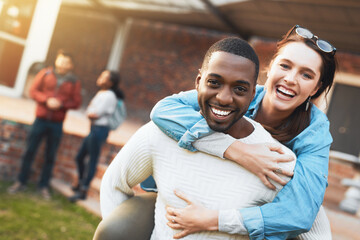 Fototapeta premium Interracial couple, portrait and students with hug for bonding, relationship or support at outdoor campus. Happy man, woman or gen z with smile in joy for piggyback, love or care together at college