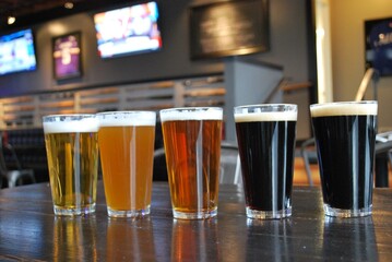 Colorful Diverse Beer Selection Glasses in Restaurant Background