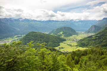 Landscape overlooking Bohinj valley, Slovenia with clouds and mountains in the background