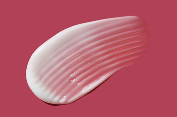 Face or body white balm milk emulsion cream hair balm red claret plum background