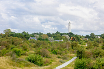 Small town houses between dune with white lighthouse, The south tower (Zuidertoren),...