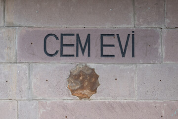 Cem evi sign on the building wall. Cem evi  "a house of gathering" in Turkish)  is a place of fundamental importance for Turkey's Alevi-Bektashiyyah tariqa populations, Ankara, Turkey.