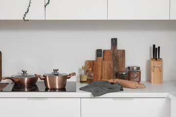 Cutting boards with food and utensils on counter in kitchen