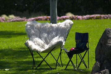 pink fuzzy folding chair next to child chair