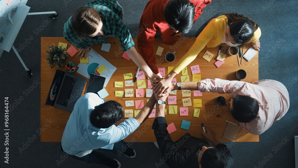 Poster top view of diverse business team putting hand together and clapping hand while brainstorming market